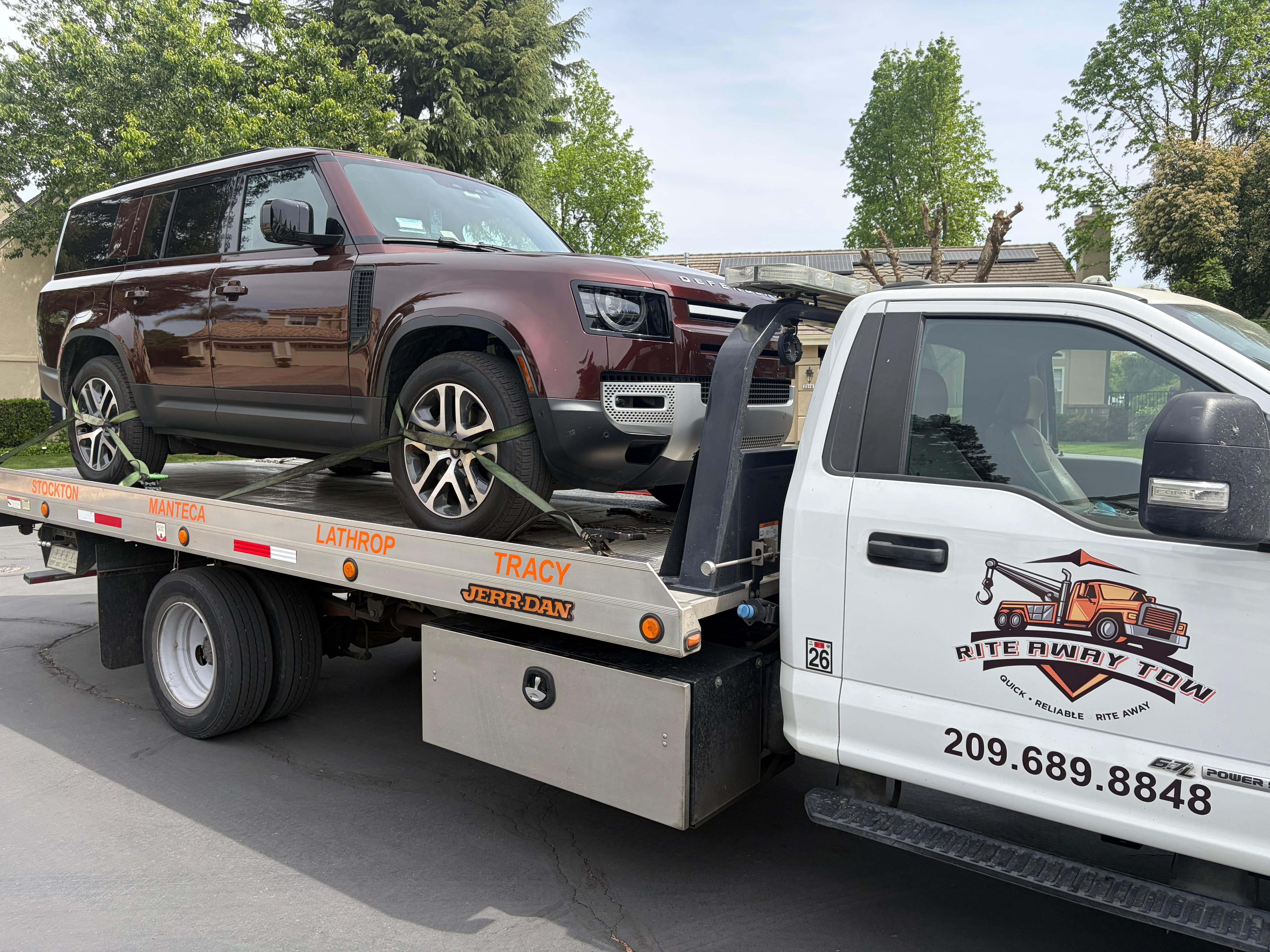 Land Rover Defender SUV loaded on a Rite Away Tow flatbed for transport