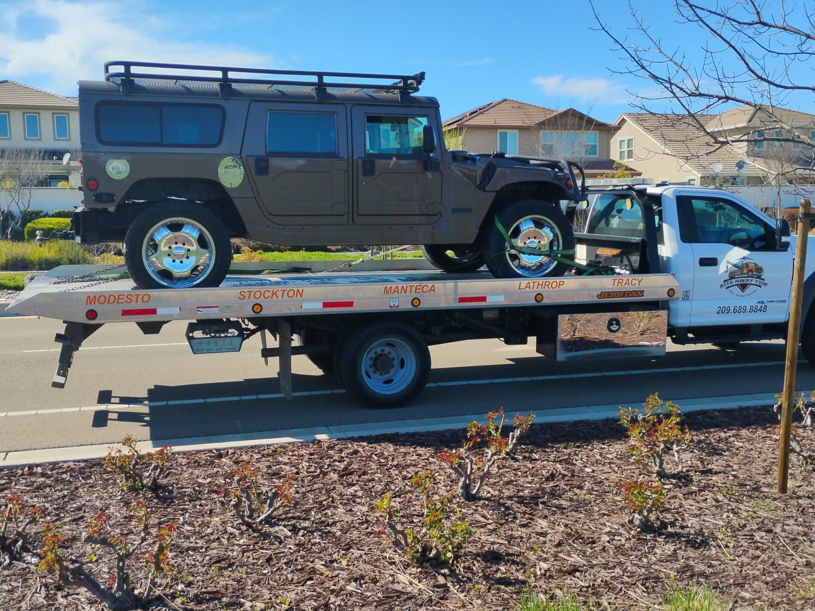 Hummer H1 secured on a Rite Away Tow flatbed in the Central Valley
