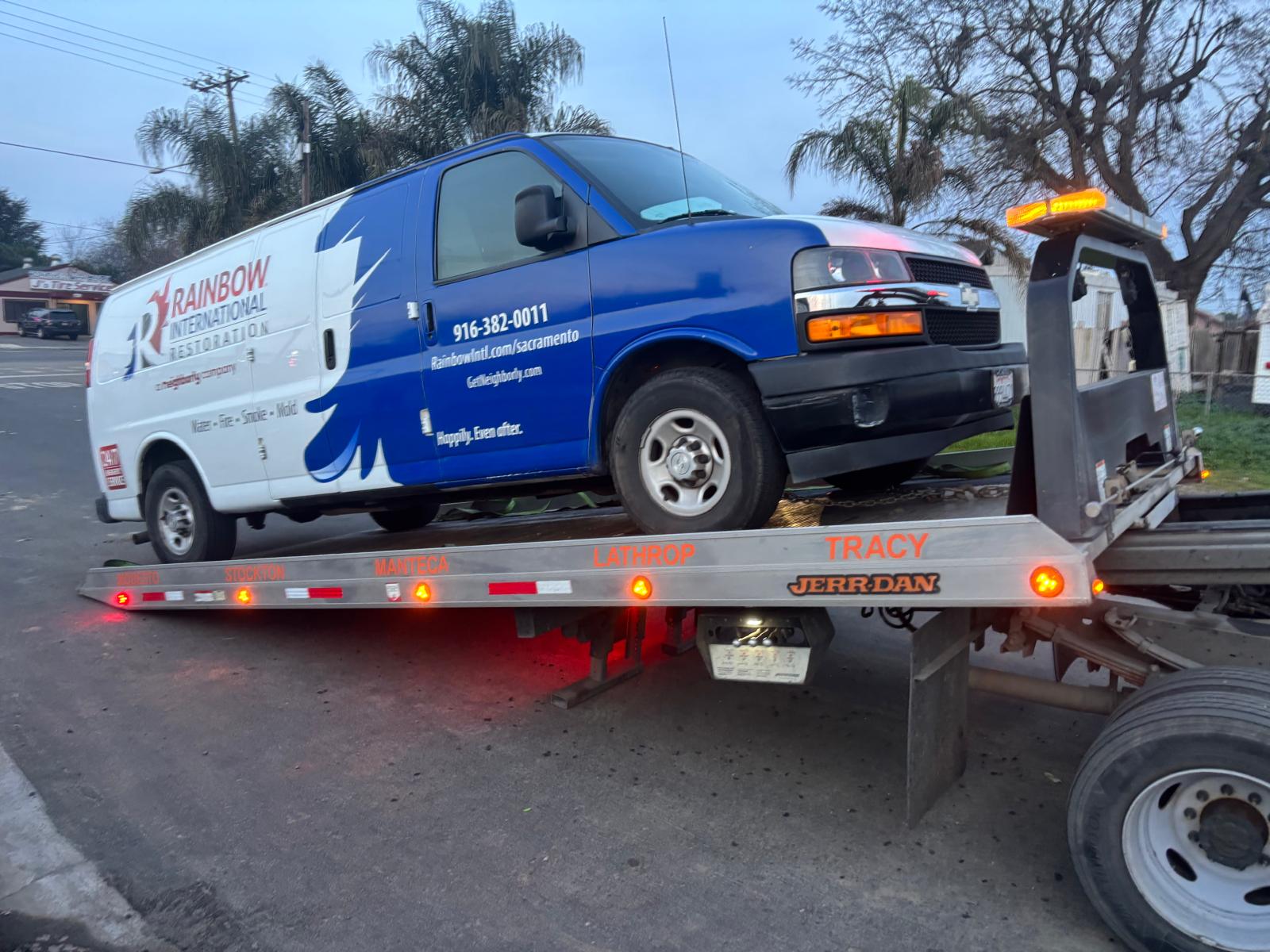 Commercial service van on a Rite Away Tow flatbed for long-distance transport
