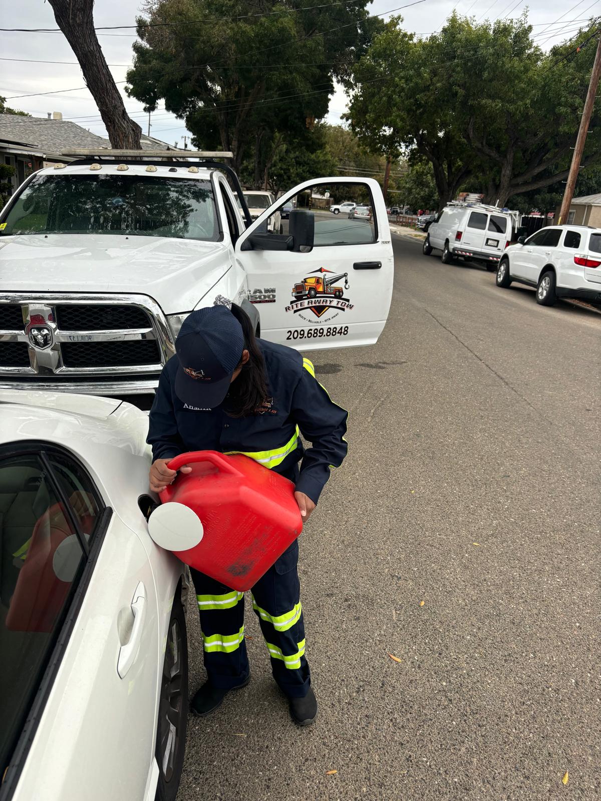 Rite Away Tow technician delivering emergency fuel to a stranded vehicle